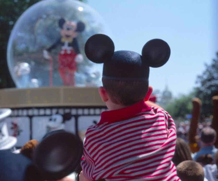 A Boy Wearing a Disney Themed Hat at Mickeys Parade in Magic Kingdom