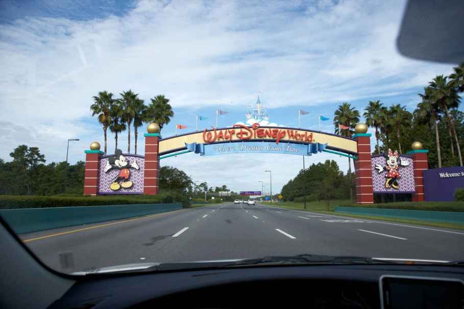 A Car Driving Through the Entrance to Walt Disney World Resorts in Orlando