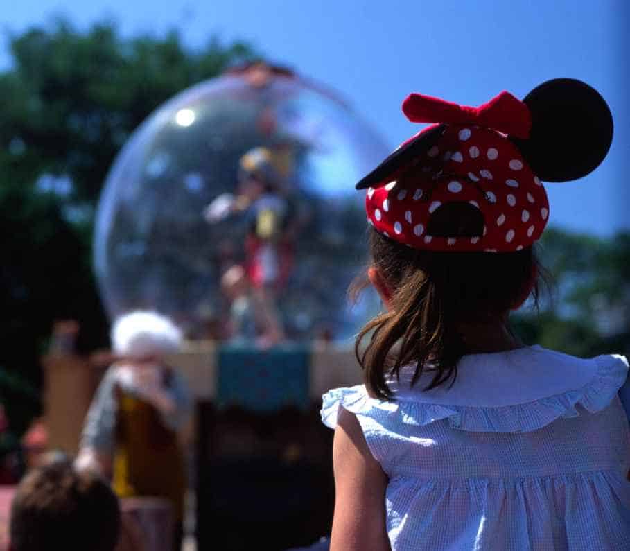 A Girl Watching the Mickeys Parade at Magic Kingdom Florida While Wearing a Disney Themed Headband