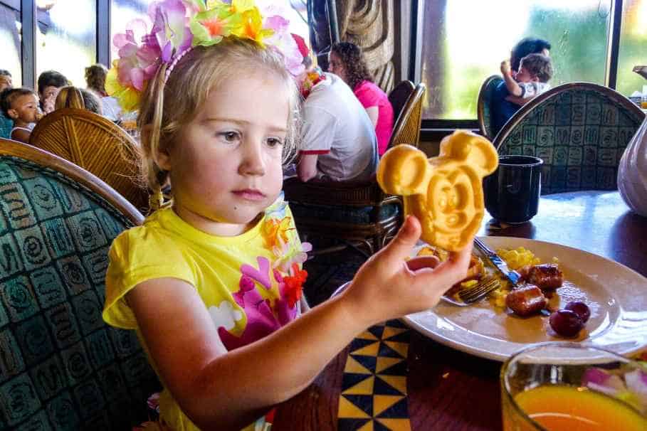 A Kid holding a Mickey Mouse waffle in Disney World Florida