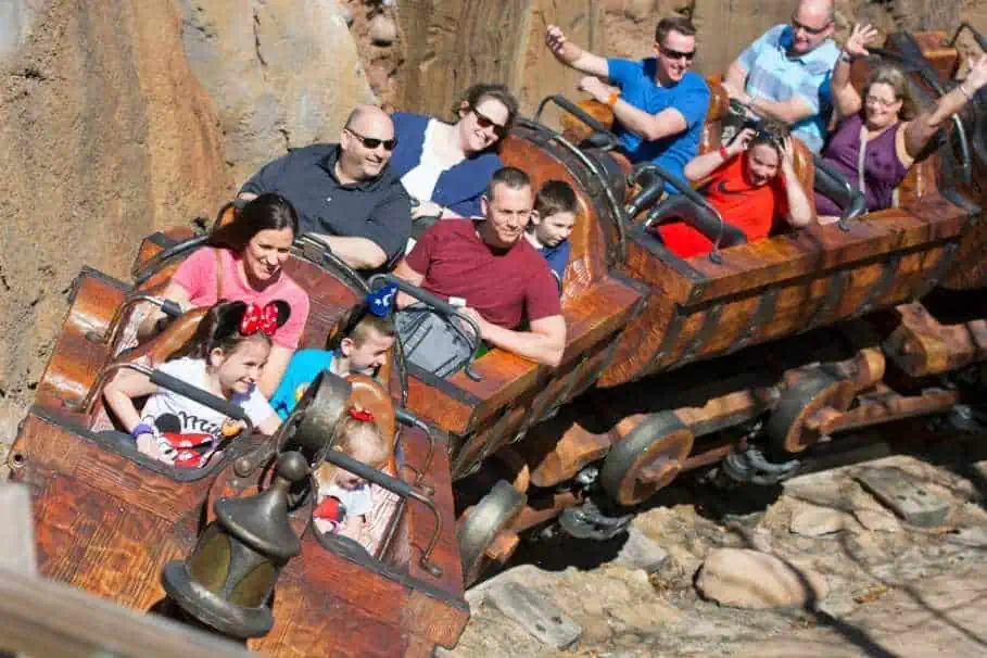 People enjoying a ride on the Seven Dwarfs Mine Train Ride at the Magic Kingdom