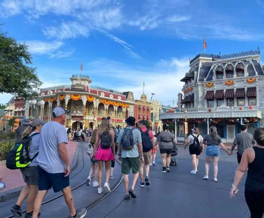 Roadside view of tourists in Comfortable Clothes walking down the main street USA at the Magic Kingdom