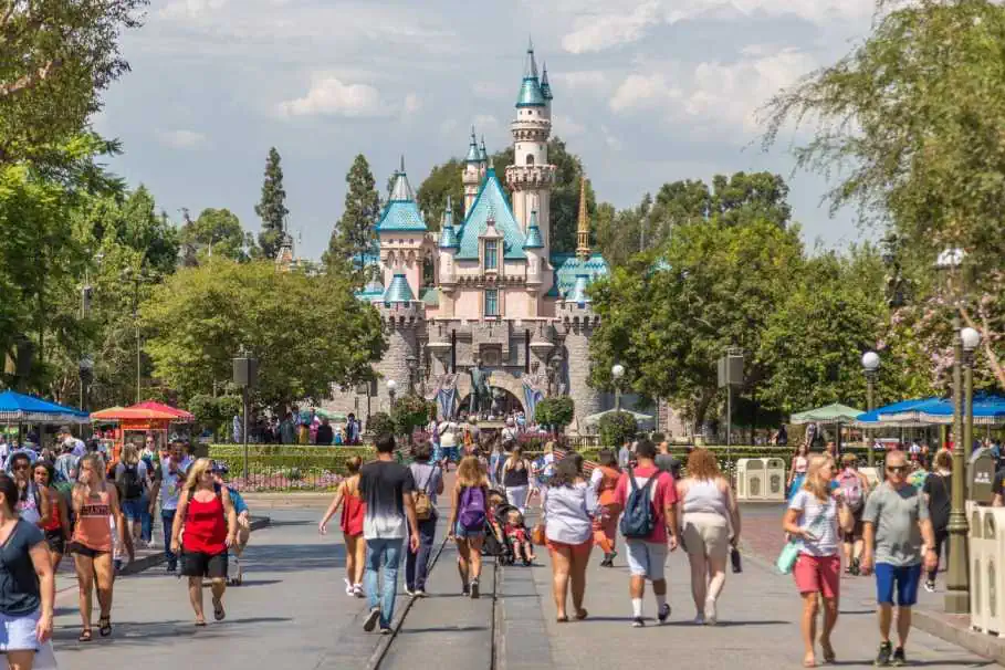 Visitors are Walking in front of the Sleeping Beauty Castle in Disneyland Resort